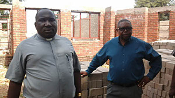 fr-chibhira-and-one-of-the-parishioners-at-a-presbitery-project-sponsored-by-missio-at-st-edwards-kwekwe-crop-u16385